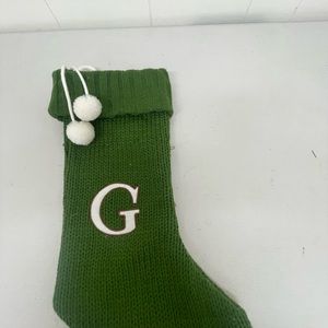 • Knit monogram Christmas stocking in green with white letter G.